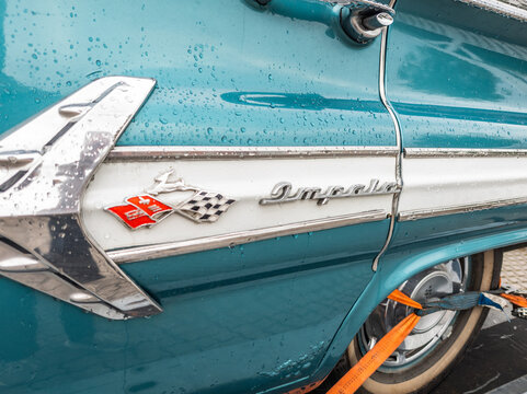 6 july 2025,Maribo, Denmark. Chevrolet impala, detailed side logo emblem, turquoise color scheme with white hard top, hardtop sedan. Vintage car. American classic car with a striking color. Nostalgic 