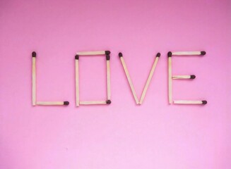 Word LOVE Made of Matchsticks on Pink Background, Minimal Concept