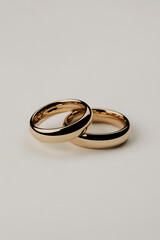Two gold wedding bands placed together on a clean white background representing love and commitment for propose day