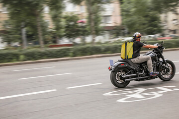 Abstract image of a courier on a motorcycle on a blurred background