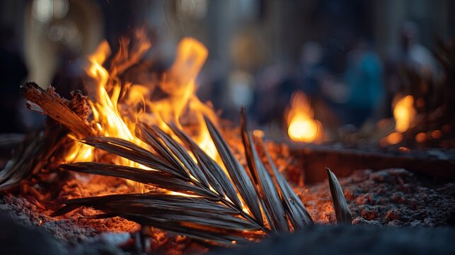 A burning palm branch on Ash Wednesday, symbolizing repentance and renewal in a Christian religious context.