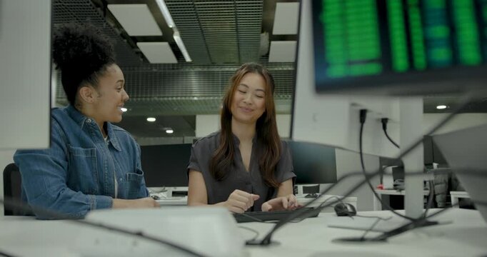 Two individuals collaborating in a modern tech office