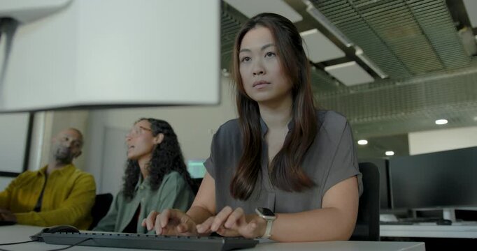 Focused businesswoman working at her desk in a modern workspace office