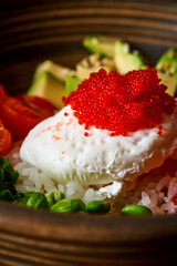 Fresh salmon poke bowl with poached egg, avocado, and edamame.