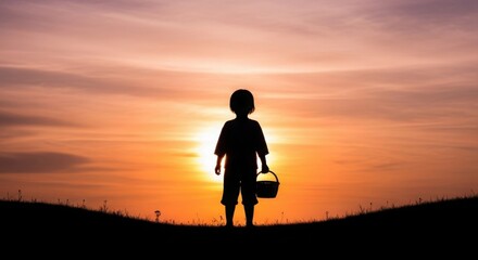 Fototapeta premium Silhouette of a child holding an Easter basket against a dramatic sunset