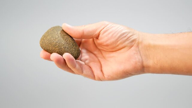 Polished Neolithic Stone Axe in Hand, Prehistoric Artifact Heritage. slow motion. 4k at 50 fps