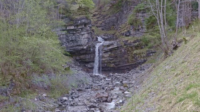 Waterfall in the mountains. Water falls from the from cascades. Bottom part of Diesbachfall waterfall, canton Glarus, Switzerland.