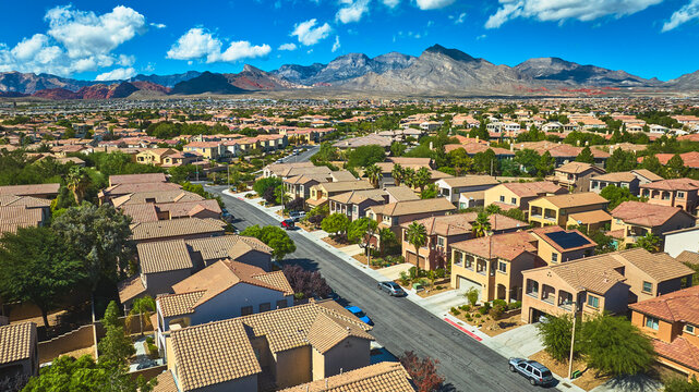 Aerial Las Vegas Residential Neighborhood With Red Rock Mountain And Blue Sky