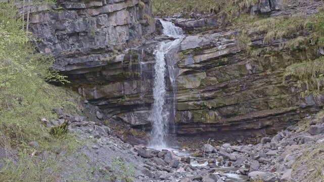 Waterfall in the mountains. Water falls from the from cascades. Bottom part of Diesbachfall waterfall, canton Glarus, Switzerland.