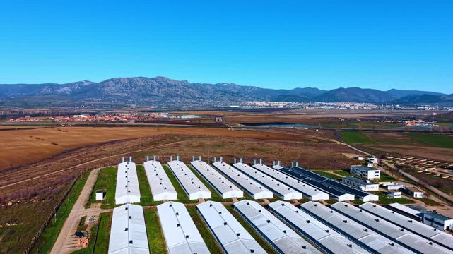 Industrial farm buildings panorama. Wide aerial panorama of modern farm facilities surrounded by open rural land