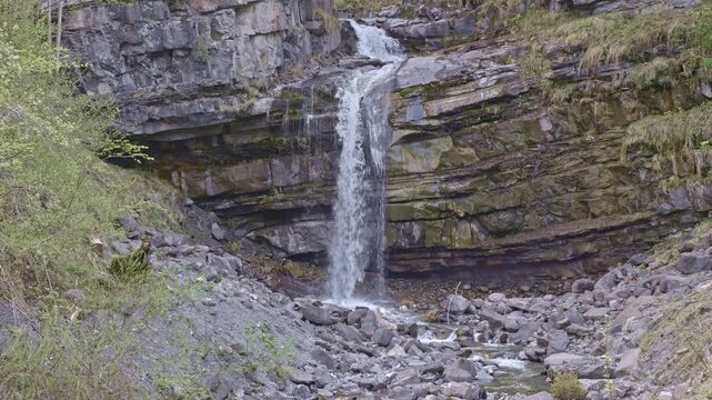 Waterfall in the mountains. Water falls from the from cascades. Bottom part of Diesbachfall waterfall, canton Glarus, Switzerland.