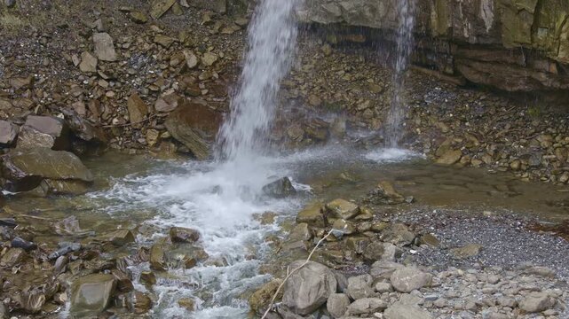 Waterfall in the mountains. Falling water close up. Water falls from the from cascades. Diesbachfall waterfall, canton Glarus, Switzerland.