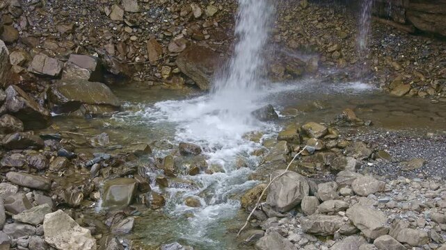 Waterfall in the mountains. Falling water close up. Water falls from the from cascades. Diesbachfall waterfall, canton Glarus, Switzerland.
