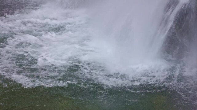 Waterfall in the mountains. Falling water close up. Water falls from the from cascades. Diesbachfall waterfall, canton Glarus, Switzerland.