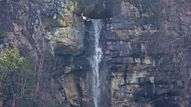 Waterfall in the mountains. Water falls from the from cascades. Top part of Diesbachfall waterfall, canton Glarus, Switzerland.