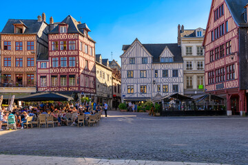 Street with timber framing houses and tables of restaurant in Rouen, Normandy, France. Architecture and landmarks of Rouen. Cozy cityscape of Rouen