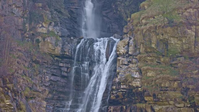 Waterfall in the mountains. Water falls from the from cascades. Top part of Diesbachfall waterfall, canton Glarus, Switzerland.