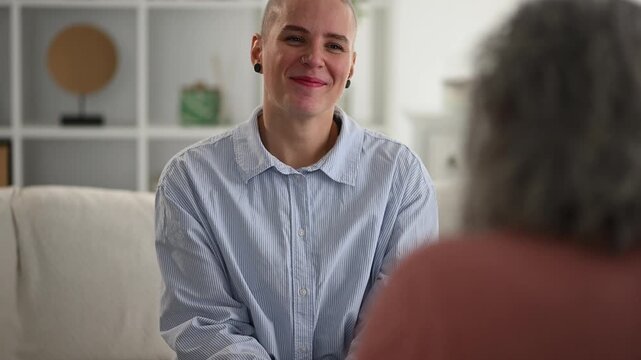 Happy androgynous person candidly chatting with a friend