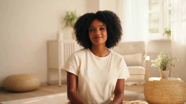 Stress relief and relaxation in serene bright room, young woman meditating with calming glowing particles, cortisol reduction concept video footage