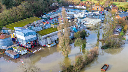 Aerial and ground-level views showing extensive flooding across the Somerset Levels near Langport,...