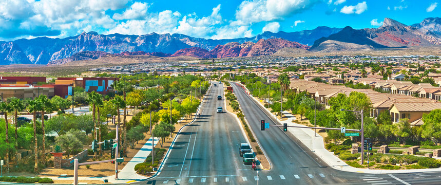 Aerial Las Vegas Neighborhood Palm Lined Streets and Red Rock Mountains Panorama