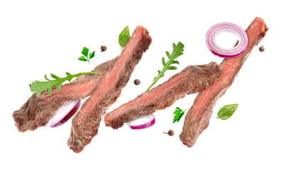 Roasted beef pieces, herbs and onion flying in air on white background