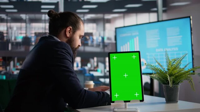 Vertical chroma key on tablet with businessman analyzing company KPIs, daily tasks for data management and reports evaluation. Documents for profitability and administration.