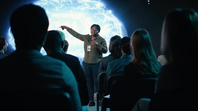Black public speaker sharing futuristic AI presentation speech virtual intelligence and programming insights. Businesswoman presents machine learning to investors in conference hall. Camera A.