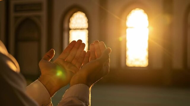 Close up of Muslim man hands raised in prayer inside a mosque with warm sunlight, Islamic spirituality and faith concept, religious supplication during Ramadan or Eid.