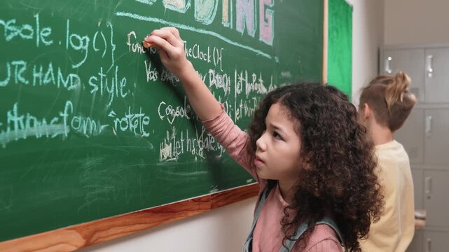American student studying coding engineering prompt while writing answer on blackboard. Intelligence girl planning and learning about coding development plan. Successful child sharing idea. Pedagogy.