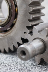 Macro shot of metal spur gears engaging, heavy duty steel gear transmission system and mechanical pinion assembly for industrial machinery engine.