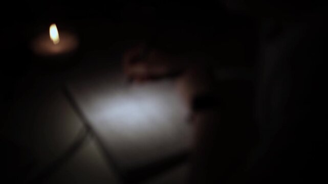 Writing Notes in Notebook by Candlelight for Self-Reflection During Depression