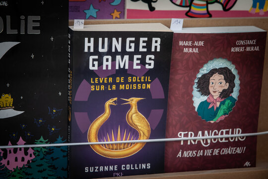 PARIS, FRANCE - JUNE 22, 2025: French edition of The Hunger Games Sunrise on the Reaping by Suzanne Collins. The book, titled Lever de Soleil sur la moisson, is displayed on a shelf in a bookstore.
