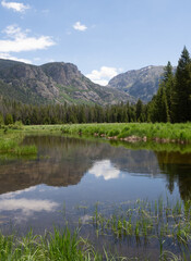 Fototapeta premium Headwaters of the Colorado River near La Poudre Pass in Colorado with Mountains and Clouds Reflected the Water