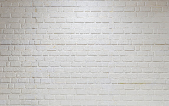 Detail of modern cream brick wall background photo. White light brick wall texture background for stone tile block painted in beige light color wallpaper modern interior and exterior backdrop design.