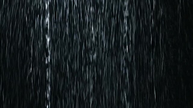 A vertical image showcasing a textured dark surface with a subtle pattern of vertical lines