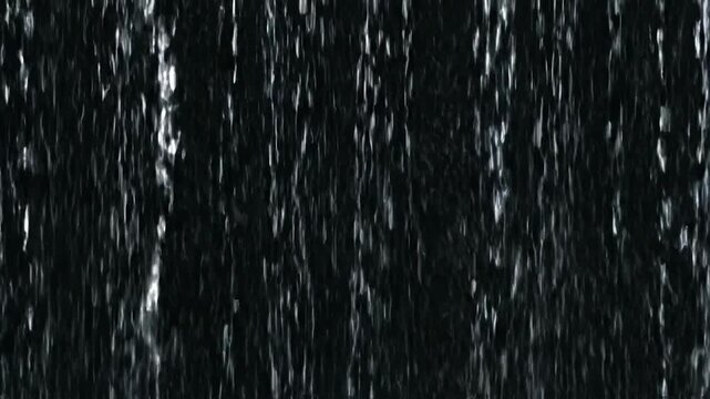 A dark, textured background with vertical streaks of white or gray, resembling rainfall