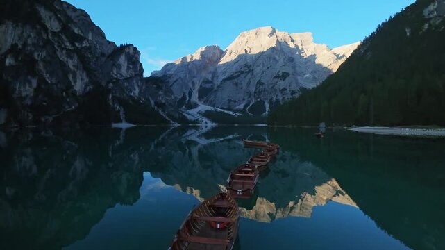 Lago Di Braies, Italy Foreground Boat Bow Leading Across Lake Toward Jagged Peaks, Wooden Hull Gliding On Turquoise Water, Vivid Reflections Of Alpine Ridges, Intimate Exploration Mood
