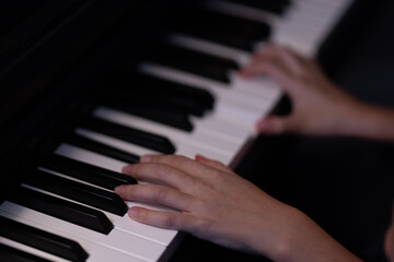 Fototapeta premium Hands playing piano, music education and learning concept.
