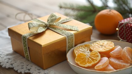 Golden Orange Gift Box a Glittering Bow and Fresh Sliced Citrus Fruit in Soft Focus Festive