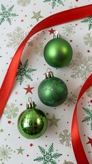 Green Christmas ornaments and red ribbon on festive background