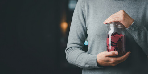 Hand jar love emotion thank with gratitude bokeh light charity care holiday concept nubes valentine gift hand holding glass jar of heart shape paper symbol of love and gratitude for charity