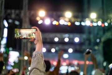 Audience filming the concert hall