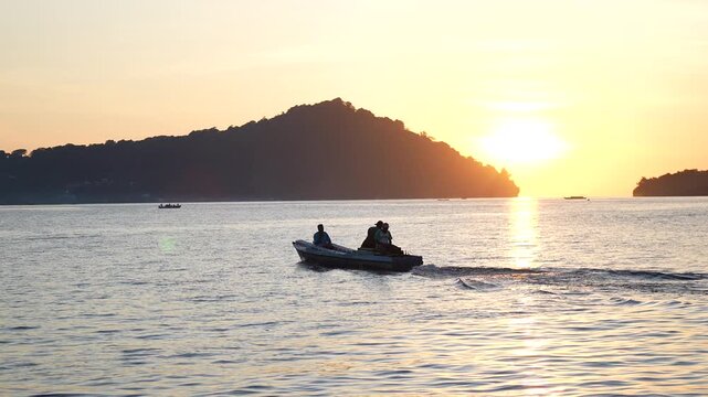 fishing boat in the sea at sunset