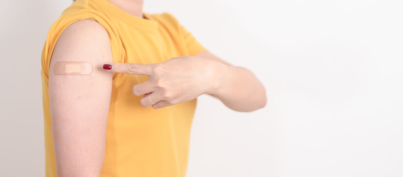 Adult Woman with bandage after received vaccine. Vaccination and Immunization for Influenza, HPV, Zoster, IPD, DTP or Diphtheria, Tetanus and Pertussis, MMR, Hepatitis B, Covid and Nipha virus vaccine
