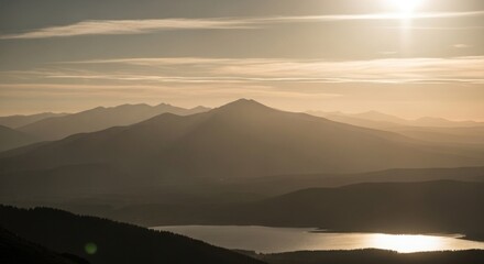 Fototapeta premium Mountain range with lake and sun rays shining through atmospheric haze