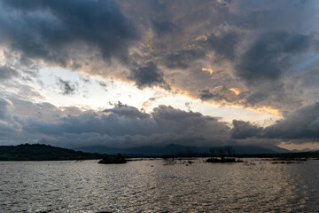 Landscape view of majestic clouds in the sky sunset or sunrise over sea