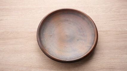 Empty round clay plate, Indonesian pottery