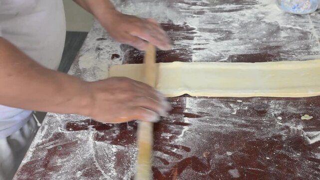 FLATTENING THE SWEET BREAD DOUGH