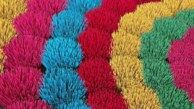 Close-up view of colorful incense sticks arranged in vibrant abstract patterns in Vietnam. Traditional symbol of Asian culture, spirituality, rituals, and everyday life.